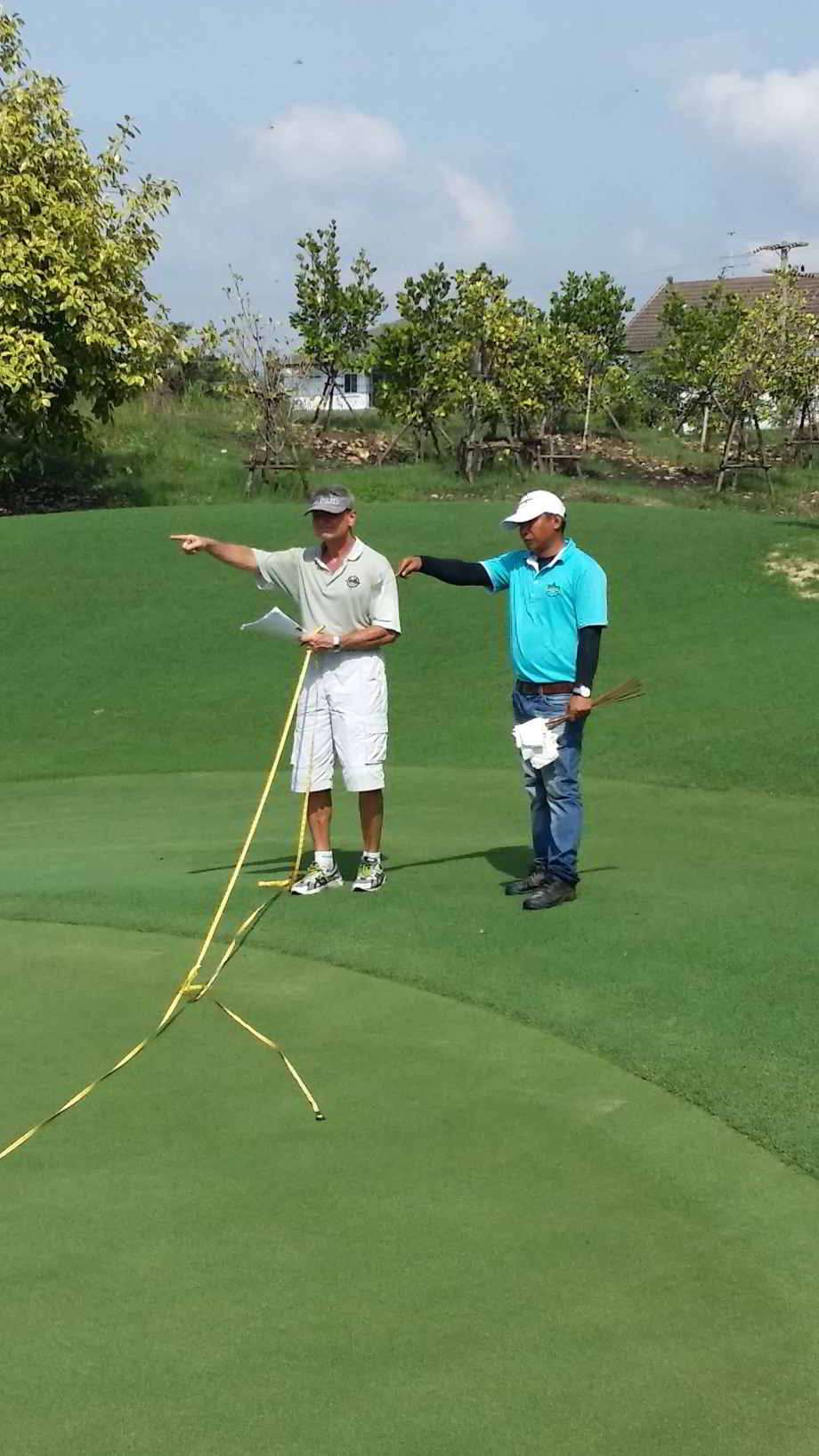 James Schumacher, President of ATI supervising the all-important sprinkler layout around the greens. inspecting the work of the contractor and programming the new system into the computer.